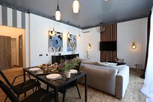 a living room with a table and a couch at Villa Bonapart in Zatoka