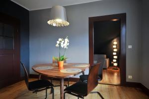 a dining room with a wooden table and chairs at Appartement Grenier à sel Gentleman in Colmar