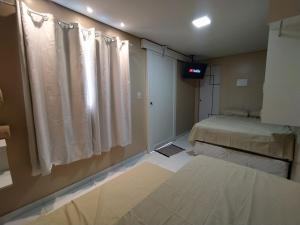 Giường trong phòng chung tại Container LB com garagem para carros de até 4,5M