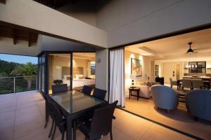 a room with a dining table and a living room at Simola Hotel, Country Club & Spa in Knysna