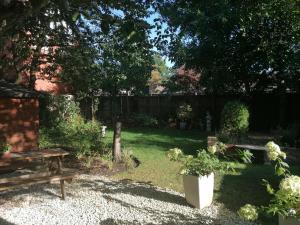 a backyard with a picnic table and a bench at The Claremont in Woodhall Spa