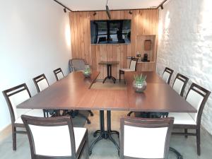 a dining room with a large table and chairs at Hôtel La Brasserie in Treignac
