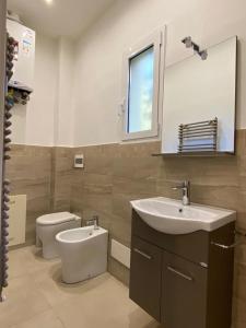 a bathroom with a sink and a toilet and a mirror at DaRò Apartments in Bologna +12 photos