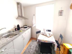 a kitchen with a sink and a counter top at Modern Apartment in Guimarães, 50 m², Balcony in Guimarães +4 photos