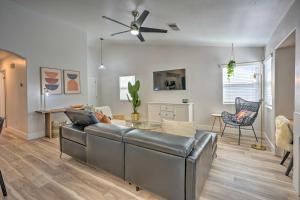 a living room with a couch and a table at Stylish Bakersfield Getaway with Pool Table! in Bakersfield