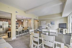 a dining room and kitchen with a table and chairs at Grand Haven Condo with Patio Less Than 1 Mi to Downtown in Grand Haven