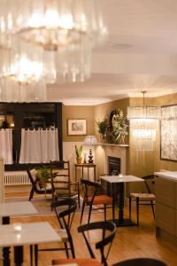 a dining room with tables and chairs and a chandelier at The Yard in Bath Hotel in Bath