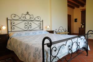 a bedroom with a bed with a wrought iron headboard at Relais Ca' Serena in Roncade +106 photos