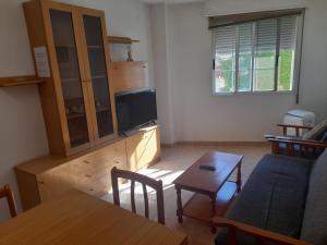 a living room with a couch and a table at Apartamentos Chelo in Navajas