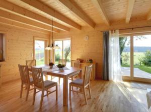 a dining room with a wooden table and chairs at Ferienhaus Eller in Traunwalchen