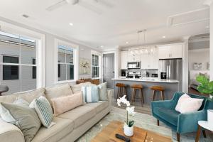 a living room with a couch and a kitchen at The Wando Suite at 122 Spring in Charleston