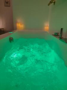 a large tub filled with blue water in a room at Il Sitarein in Bologna