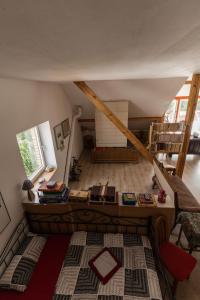 an attic room with a bed and a staircase at Traumhafte Ferienwohnung in Ratzeburg