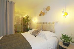 - une chambre avec un grand lit blanc et une douche dans l'établissement L'Evasion Lourdaise Terrasse Centre Parking wifi, à Lourdes