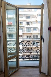 a door to a balcony with a view of a building at Hotel Intersur Recoleta in Buenos Aires