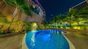 a swimming pool in a hotel at night at Amazon Taiamã Hotel in Cuiabá