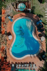 an overhead view of a swimming pool with chairs around it at Pousada Sabledor in Búzios