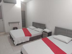 Postel nebo postele na pokoji v ubytování Hotel Gueicer Cucuta
