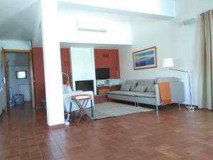 a living room with a couch and a table at Casa da Achada - Fonte Salgada in Tavira