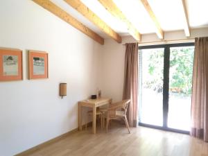 a dining room with a table and a large window at Casa da Achada - Fonte Salgada in Tavira