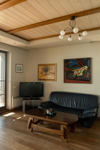 a living room with a couch and a coffee table at Pilėja in Neringa