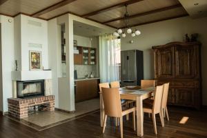 a kitchen and dining room with a table and chairs at Pilėja in Neringa