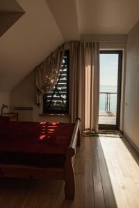 a bedroom with a bed and a large window at Pilėja in Neringa