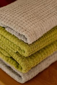 four towels stacked on top of each other on a table at Pilėja in Neringa +108 photos