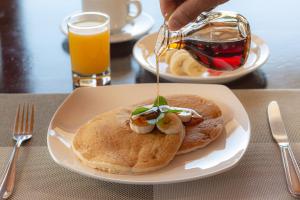 a plate of pancakes with shrimp on top with syrup at Mar Inn Costa Rica in Monteverde Costa Rica