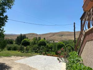 a view of a garden with mountains in the background at Noravank B&B in Chʼiva