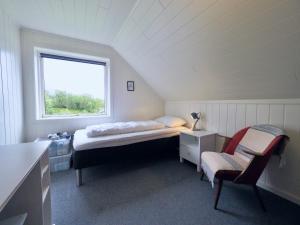 a small room with a bed and a window at Fishermans Village Lofoten in Alstad