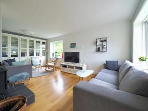 a living room with a couch and a tv at Fishermans Village Lofoten in Alstad