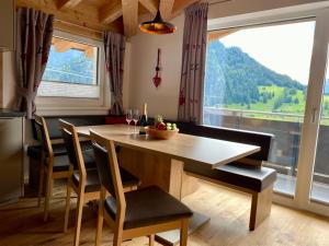 a dining room with a table and a large window at Mountain Apart Nauders in Nauders
