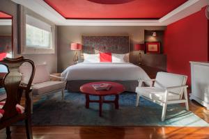 a bedroom with a large bed and a red wall at Pug Seal Coyoacan in Mexico City