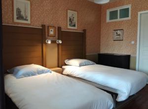 2 Betten in einem Hotelzimmer mit 2 Schlafzimmern in der Unterkunft Gîte les 4 Vents in Pradelles