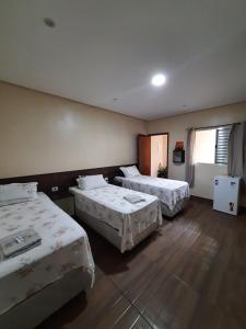 En eller flere senge i et værelse på Hotel Vila Maria