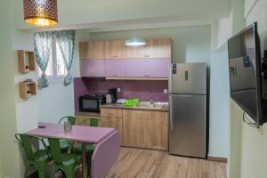 a kitchen with a stainless steel refrigerator and a table at Apartment in Asprovalta in Asprovalta