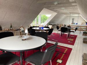 a room with tables and chairs in a building at Event4U in Nykøbing Mors