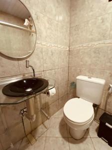 a bathroom with a toilet and a sink at Pousada Ilha Bella in Fernando de Noronha