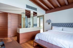 a bedroom with a large bed and a large mirror at Horizon Blu Boutique Hotel in Kalamata