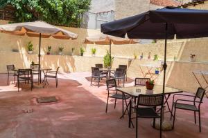 a patio with tables and chairs and umbrellas at Apartment in Asprovalta in Asprovalta