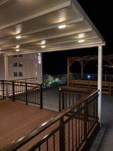 a balcony of a building at night at Overwave Apartment in Kavála