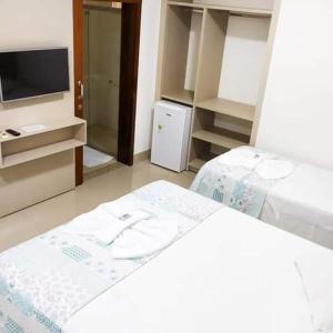 a room with a bed and a tv and a room with a tvictericter at Hotel Pepita Palace in Sinop