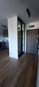 an empty room with a wooden floor and a door at Apartament Nel in Zielona Góra