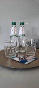 three empty glasses sitting on top of a table at Apartament Nel in Zielona Góra