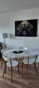 a white table and chairs in a living room at Apartament Nel in Zielona Góra
