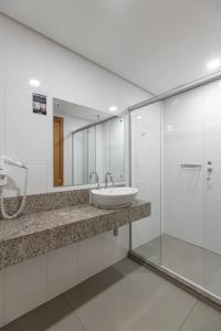 a bathroom with a sink and a mirror at Hotel Dom Rafael Premium in Santa Maria