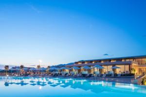 a resort with a large pool with chairs and umbrellas at Horizon Blu Boutique Hotel in Kalamata