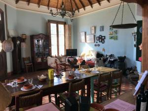 a living room with a large wooden table and chairs at Casa Bellavista in Villa Lía