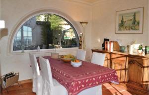 a dining room with a table with a red table cloth at Amazing Home In Le Tignet in Le Tignet